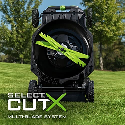 Lawn mower with multi-blade system on grass.