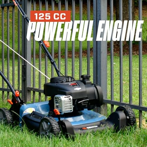 Lawnmower with 125 CC powerful engine near a fence