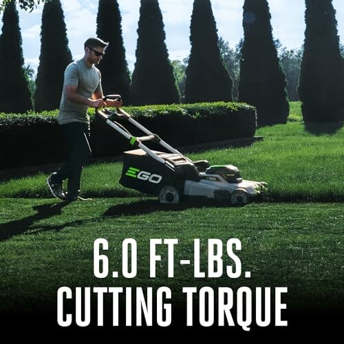 Man mowing lawn with EGO lawnmower displaying 6.0 ft-lbs cutting torque.