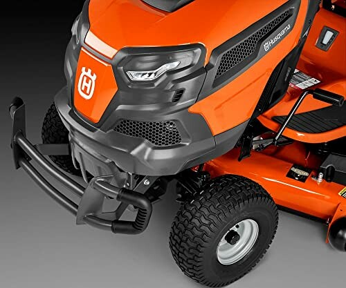 Close-up of orange Husqvarna lawn mower front