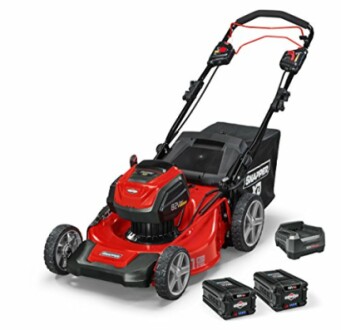 Red electric lawn mower with batteries and charger.